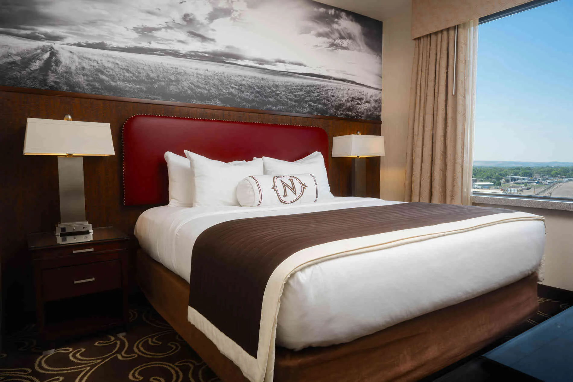 Classic guest room with king bed, soft natural light, and western-modern decor