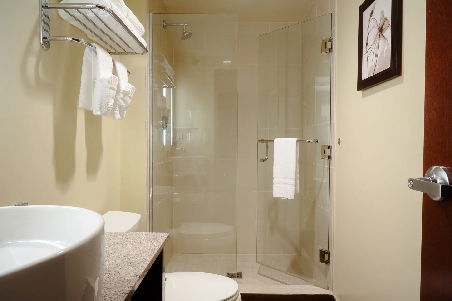 Hotel bathroom vanity with mirror, soft lighting, and Northern Hotel toiletries